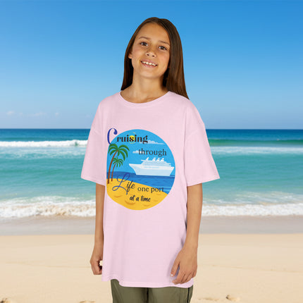 Girl wearing a pink t-shirt with a colorful ship beach and palm tree graphic design and 'Cruisin' through Life One Port at a Time' Text