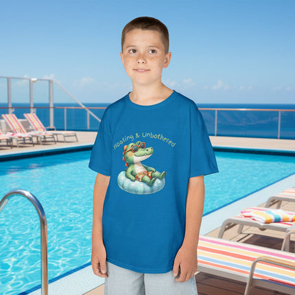 Child wearing a blue t-shirt with a graphic of a frog and "Floating and Unbothered" text
