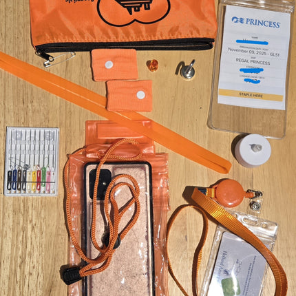 Collection of items including an orange pouch, lanyards, and a badge on a wooden surface.