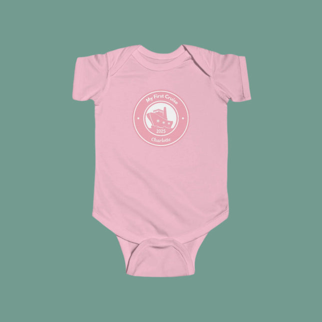 Pink baby onesie with a white graphic and text on a gray background