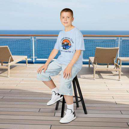 Young boy wearing a blue t-shirt with a cruise ship graphic design and text 'Countdown is Over It's Cruise Time'
