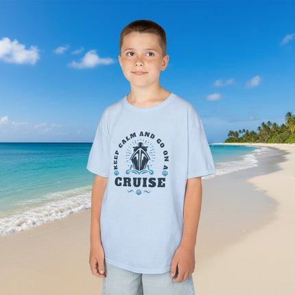 Child wearing a light blue t-shirt with 'Keep Calm and Go on a Cruise' text and graphic.