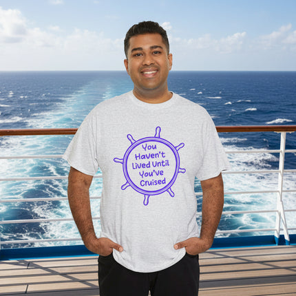 Man wearing White t-shirt with purple graphic and "You Haven't Lived Until You've Cruised" text on a boat with ocean and sky background